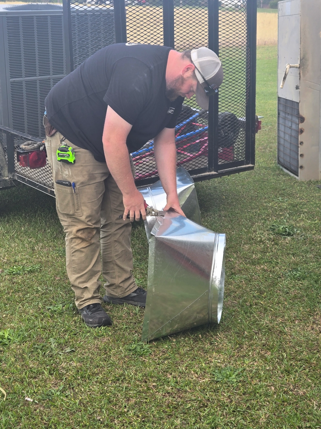 HVAC technician cutting sheet metal for ductwork in Biscoe NC